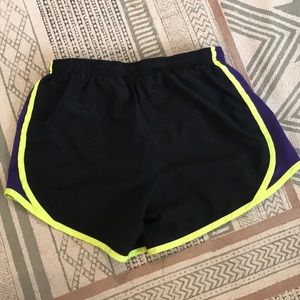 Black, neon yellow, and purple Nike running shorts